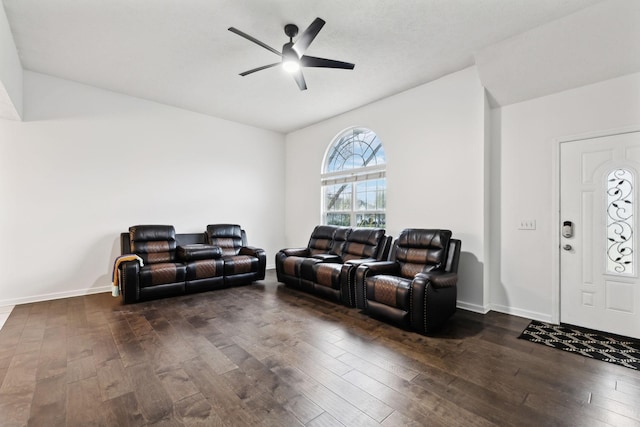 living room with dark wood-style floors, baseboards, and ceiling fan