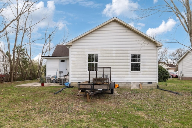 rear view of house featuring a lawn and a patio area