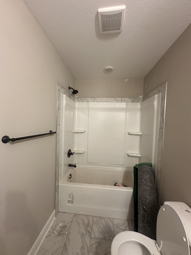 155 Cardinal Crk, Clarksville, TN 37040 - bathroom featuring toilet, marble finish floors, baseboards, a textured ceiling, and shower / tub combination