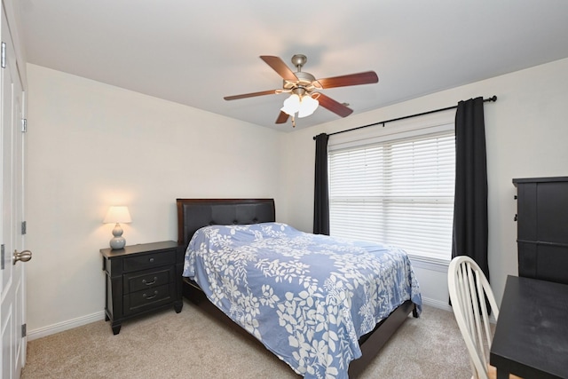 bedroom with baseboards, a ceiling fan, and light carpet