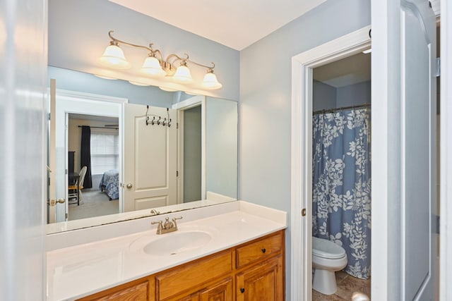 bathroom featuring vanity, a shower with curtain, connected bathroom, and toilet