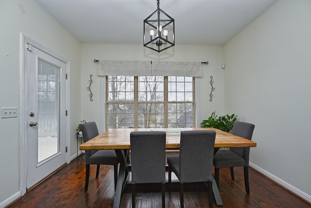 dining room featuring baseboards, a chandelier, and wood finished floors