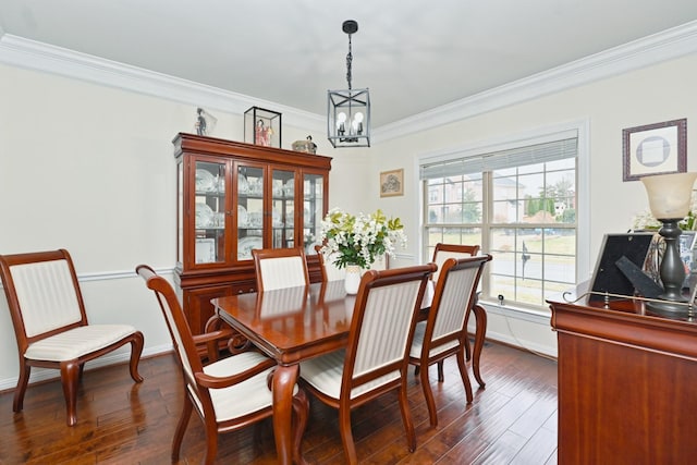 dining area featuring ornamental molding, baseboards, an inviting chandelier, and dark wood finished floors