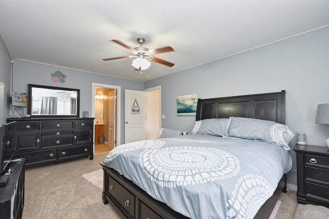 bedroom featuring ceiling fan, connected bathroom, and light carpet