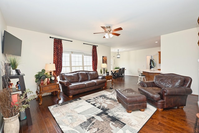 living area with hardwood / wood-style floors and ceiling fan