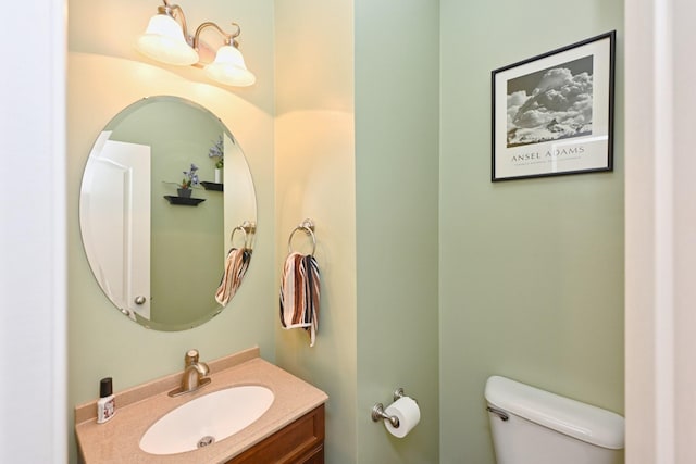 bathroom featuring toilet and vanity