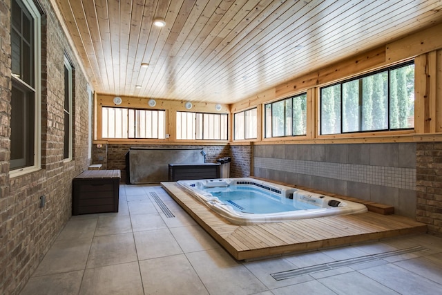 1926 20th Ave S, Nashville, TN 37212 - bathroom with tile patterned flooring, wood ceiling, brick wall, and a wealth of natural light