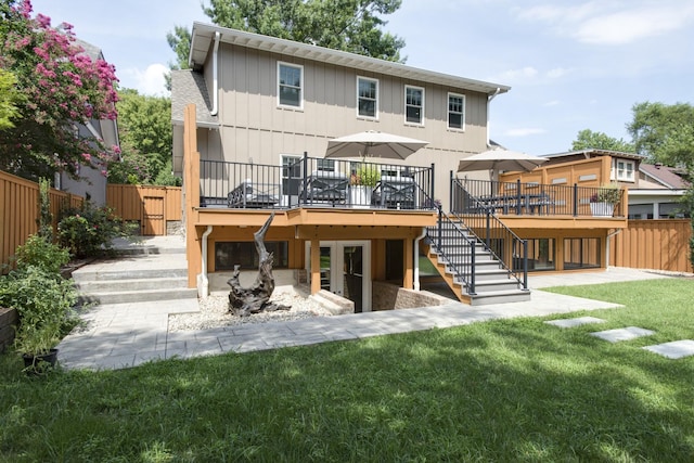 1926 20th Ave S, Nashville, TN 37212 - rear view of property with a lawn, a wooden deck, fence, and stairway