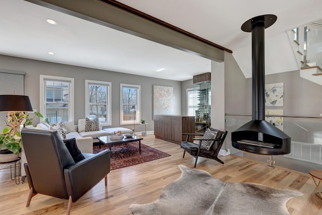 1926 20th Ave S, Nashville, TN 37212 - living room featuring stairway, wood finished floors, a wood stove, visible vents, and recessed lighting