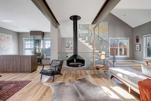 1926 20th Ave S, Nashville, TN 37212 - living area featuring wood finished floors, vaulted ceiling with beams, stairway, and a wood stove
