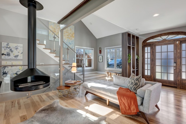 1926 20th Ave S, Nashville, TN 37212 - living area featuring high vaulted ceiling, stairway, a wood stove, and wood finished floors