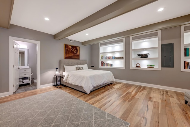 1926 20th Ave S, Nashville, TN 37212 - unfurnished bedroom featuring baseboards, wood finished floors, electric panel, and beam ceiling
