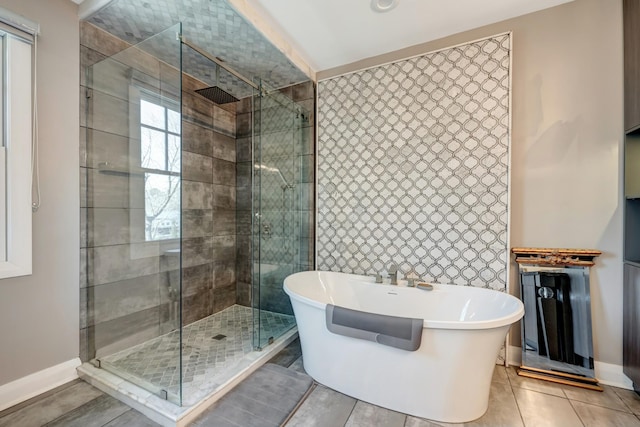 1926 20th Ave S, Nashville, TN 37212 - bathroom with a stall shower, tile patterned floors, a freestanding bath, and tile walls
