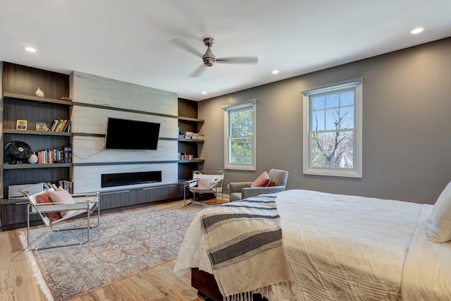 1926 20th Ave S, Nashville, TN 37212 - bedroom featuring a fireplace, wood finished floors, recessed lighting, and a ceiling fan