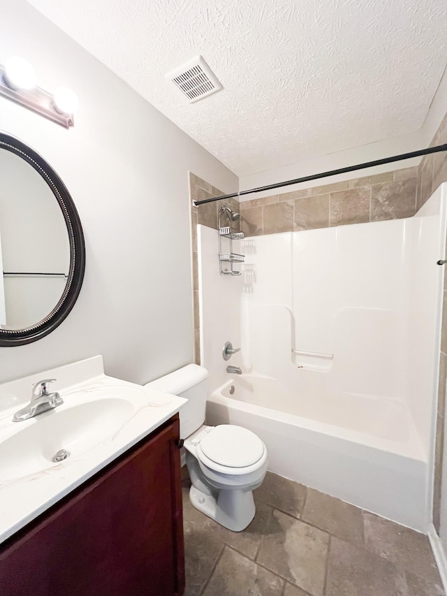 full bathroom featuring vanity, washtub / shower combination, visible vents, a textured ceiling, and toilet