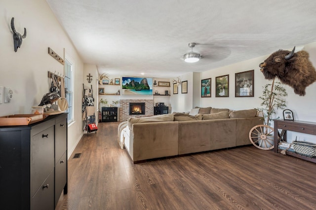 3355 Clearwater Dr, Clarksville, TN 37042 - living area with visible vents, a brick fireplace, and dark wood-type flooring