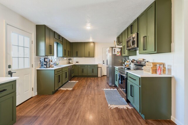 3355 Clearwater Dr, Clarksville, TN 37042 - kitchen featuring dark wood finished floors, stainless steel appliances, and green cabinetry