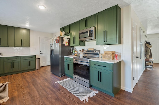 3355 Clearwater Dr, Clarksville, TN 37042 - kitchen featuring dark wood finished floors, stainless steel appliances, green cabinets, and light countertops