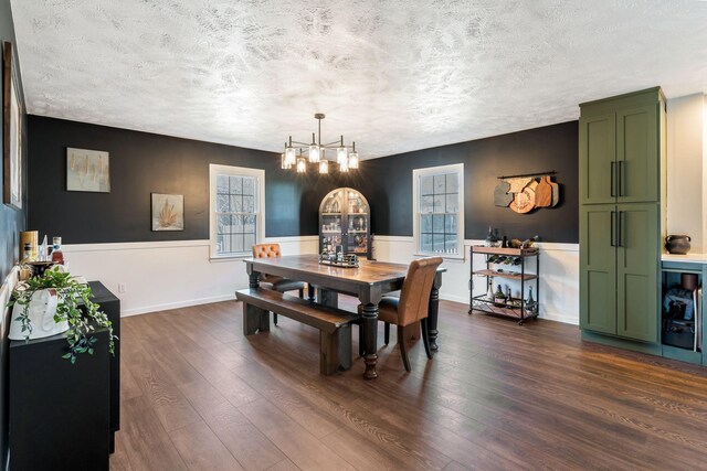 3355 Clearwater Dr, Clarksville, TN 37042 - dining room with wainscoting, a textured ceiling, dark wood-type flooring, and an inviting chandelier