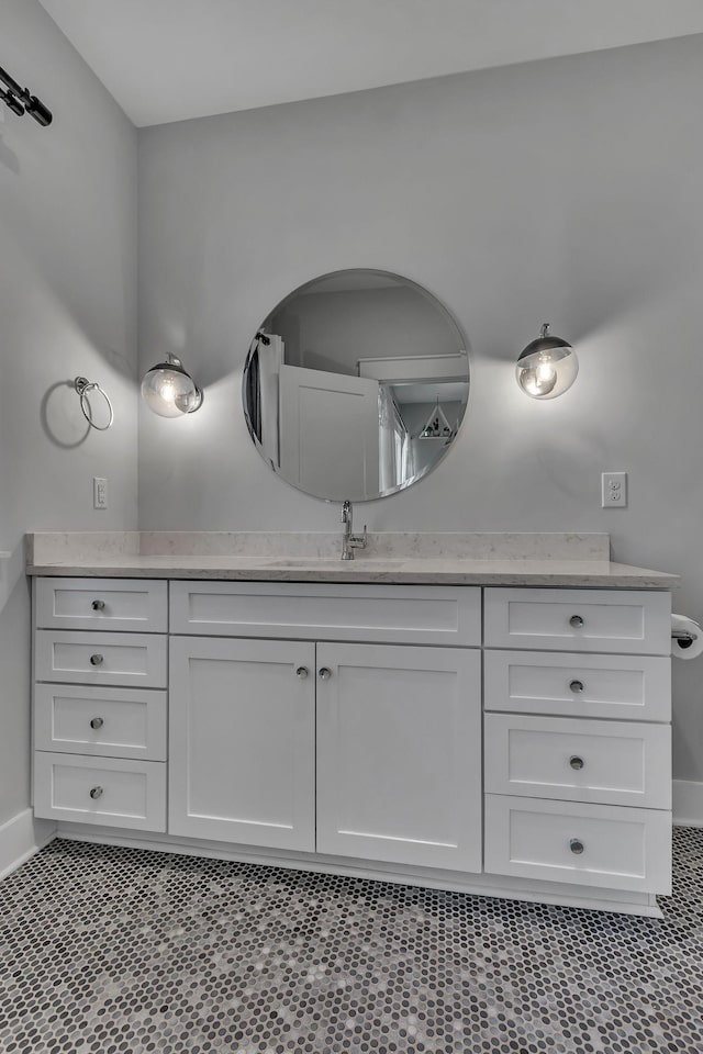 bathroom with vanity and baseboards