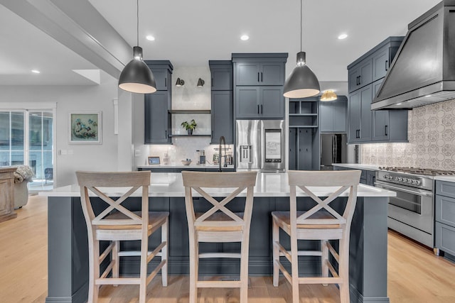 kitchen featuring light wood-style flooring, custom range hood, open shelves, appliances with stainless steel finishes, and light countertops