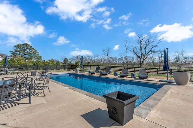 view of swimming pool with a patio, fence, and a fenced in pool