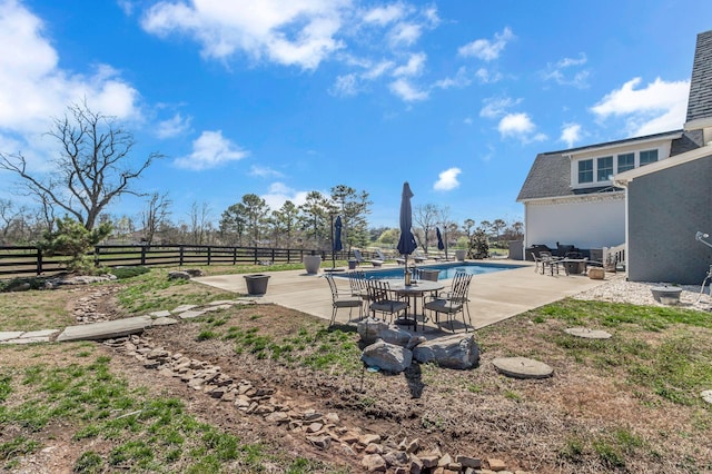 view of yard with a fenced in pool, a patio, and fence