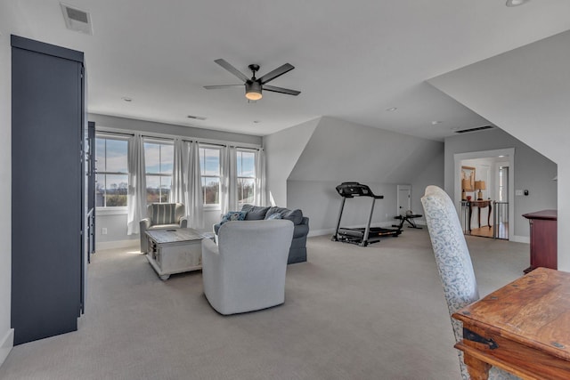 living area with visible vents, light colored carpet, baseboards, and ceiling fan