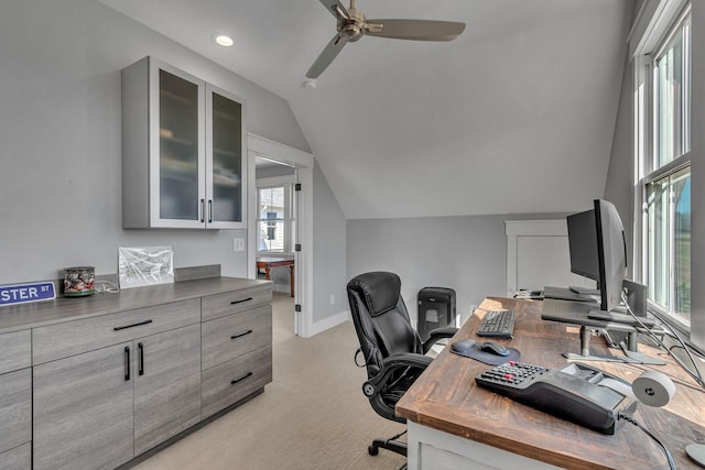 office space featuring a ceiling fan, baseboards, lofted ceiling, recessed lighting, and light colored carpet