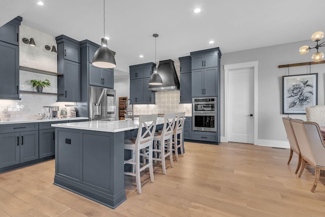 kitchen with light wood-type flooring, custom range hood, open shelves, tasteful backsplash, and light countertops