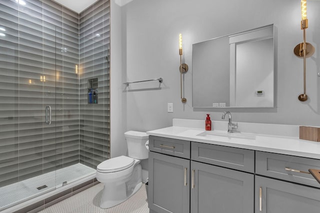 full bath featuring vanity, toilet, a shower stall, and tile patterned flooring