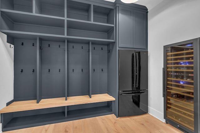 mudroom featuring wine cooler and light wood finished floors