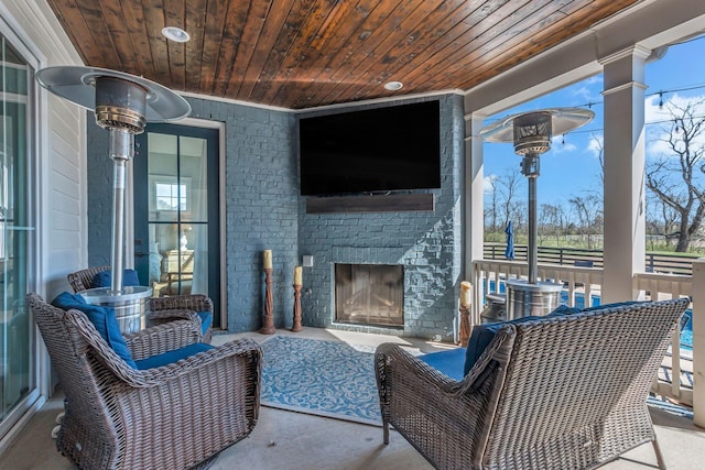 view of patio / terrace featuring an outdoor brick fireplace