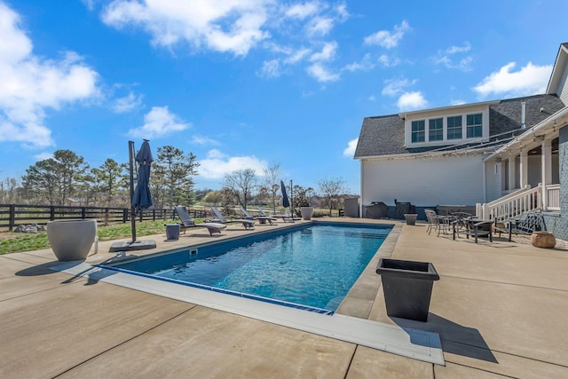 view of swimming pool with a fenced in pool, fence, and a patio area