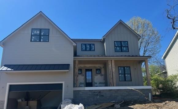 219 37th Ave N, Nashville, TN 37209 - view of front facade featuring a garage, board and batten siding, covered porch, metal roof, and a standing seam roof