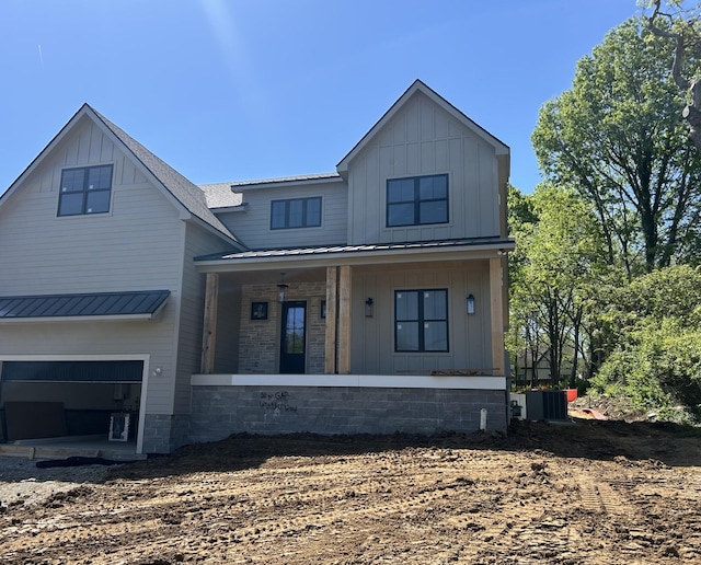 219 37th Ave N, Nashville, TN 37209 - view of front of house featuring metal roof, board and batten siding, a standing seam roof, covered porch, and a garage