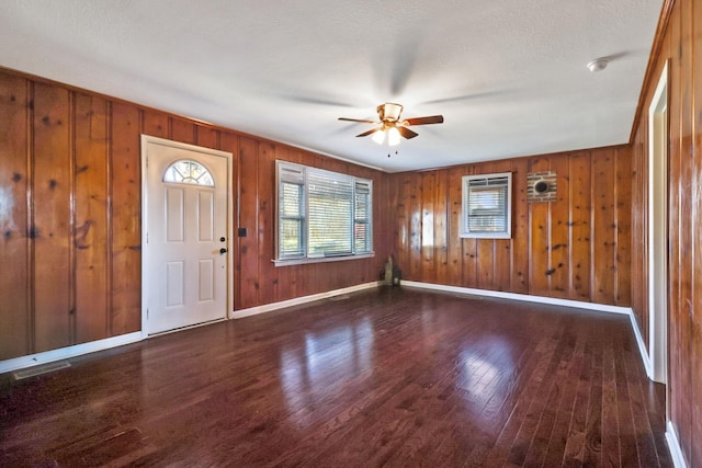 entryway featuring visible vents, baseboards, wood finished floors, and a ceiling fan
