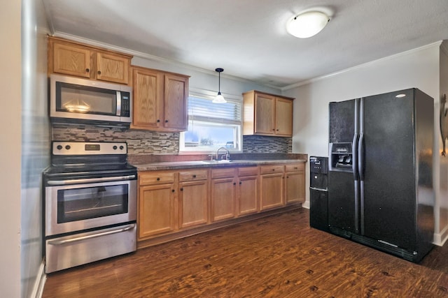 kitchen with dark countertops, stainless steel appliances, crown molding, and dark wood-type flooring