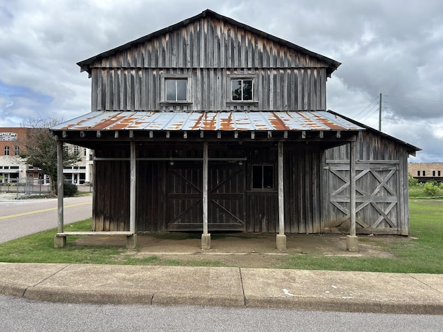 245 Cypress Lake Cv, Arlington, TN 38002 - view of front of house with board and batten siding, a metal roof, an outbuilding, and a standing seam roof
