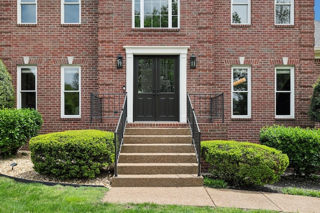 view of exterior entry with brick siding