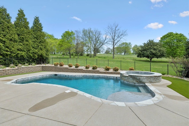 view of swimming pool with a yard, a pool with connected hot tub, a patio, and a fenced backyard