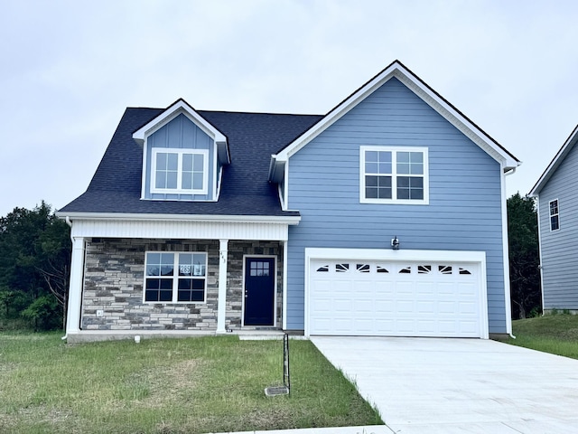 443 Generosity Way, Smyrna, TN 37167 - view of front of house with driveway, a front lawn, a porch, stone siding, and a garage