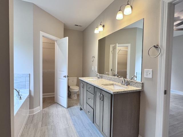 443 Generosity Way, Smyrna, TN 37167 - bathroom with toilet, baseboards, a spacious closet, a garden tub, and double vanity