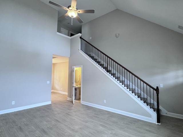 443 Generosity Way, Smyrna, TN 37167 - unfurnished living room featuring stairs, a ceiling fan, wood finished floors, and high vaulted ceiling