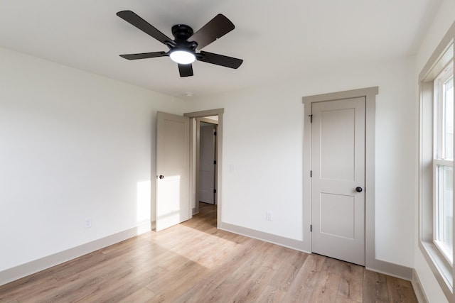 unfurnished bedroom with baseboards, a ceiling fan, and light wood finished floors