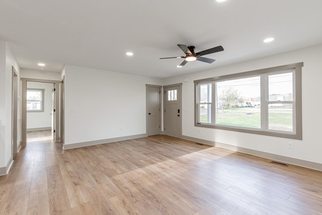 interior space featuring a ceiling fan, a healthy amount of sunlight, and light wood-type flooring
