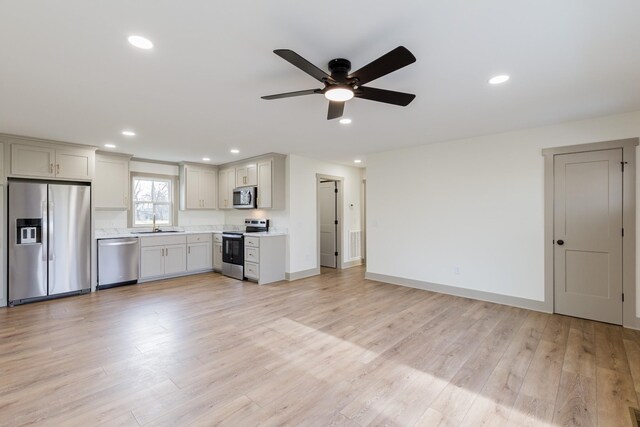 kitchen featuring light wood-type flooring, light countertops, recessed lighting, appliances with stainless steel finishes, and a ceiling fan