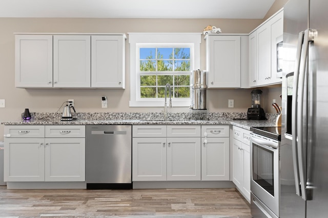2619 Prospect Rd, Dalton, GA 30721 - kitchen with light stone counters, stainless steel appliances, light wood-type flooring, and a sink