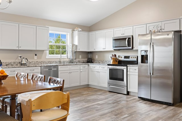2619 Prospect Rd, Dalton, GA 30721 - kitchen with vaulted ceiling, light wood-style floors, white cabinets, stainless steel appliances, and a sink