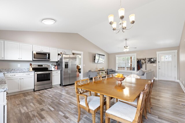 2619 Prospect Rd, Dalton, GA 30721 - dining area with baseboards, lofted ceiling, ceiling fan with notable chandelier, and light wood finished floors